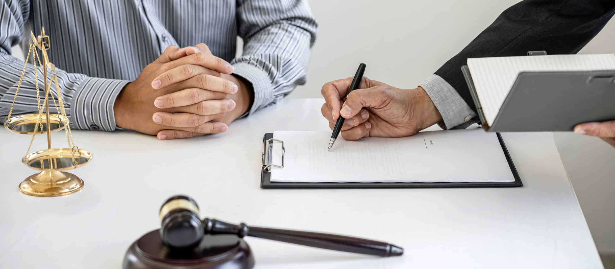 judge gavel with scales justice businessman lawyer counselor consulting discussing contract papers law firm office scaled עורך דין ירושות